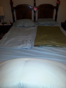Folded sheets on a queen bed